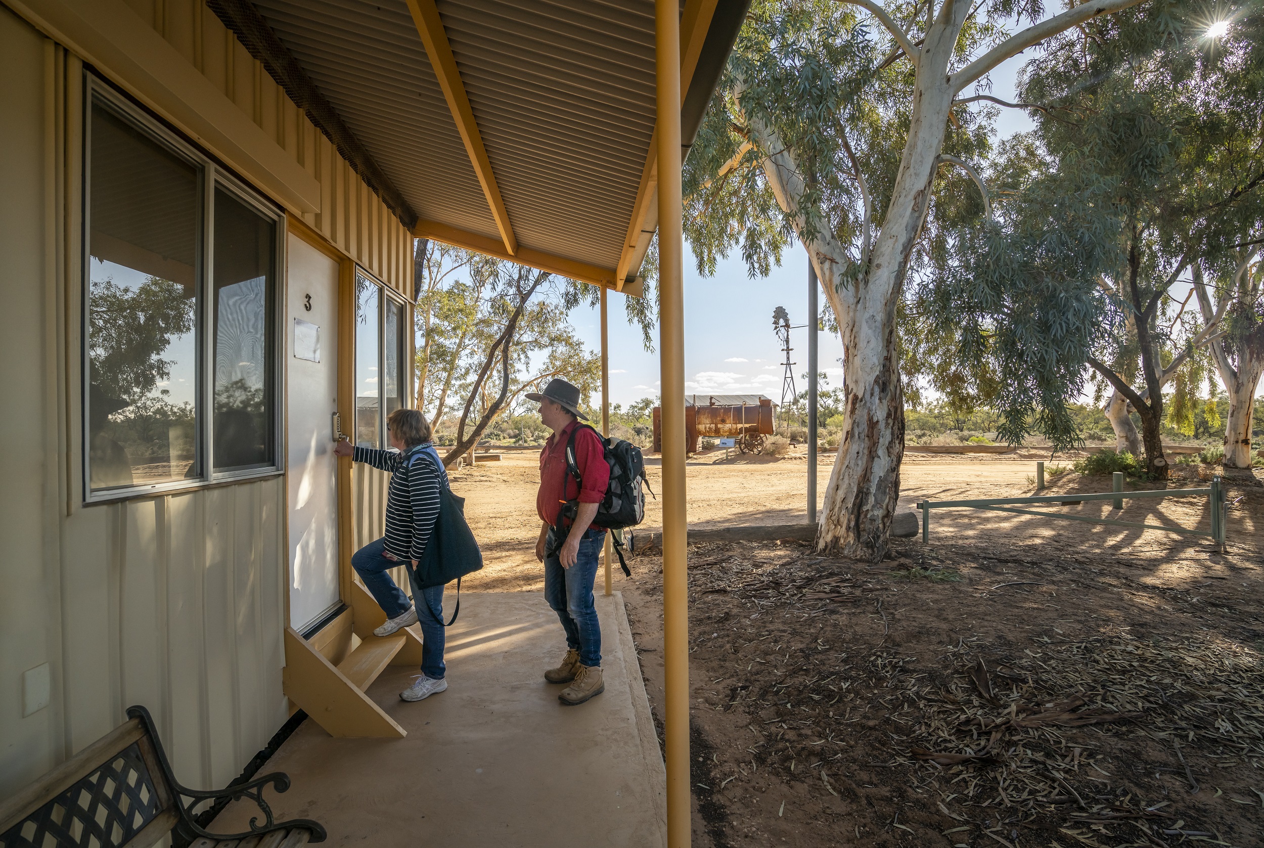 A couple entering their Kinchega Shearers' Quarters accommodation. Photo credit: John spencer/DCCEEW