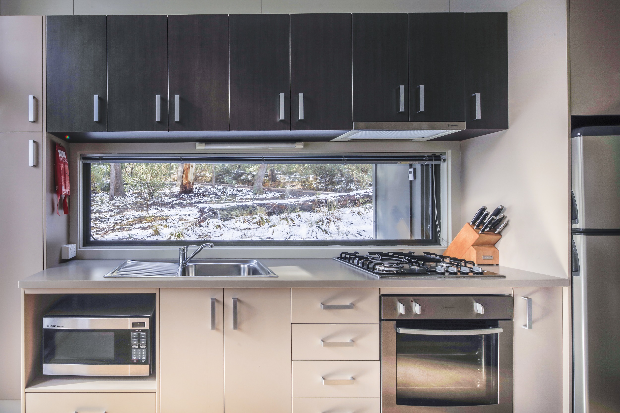 The veiw of a snow-covered landscape from the kitchen window of Lyrebird Cottage. Photo credit: Murray Vanderveer/DCCEEW