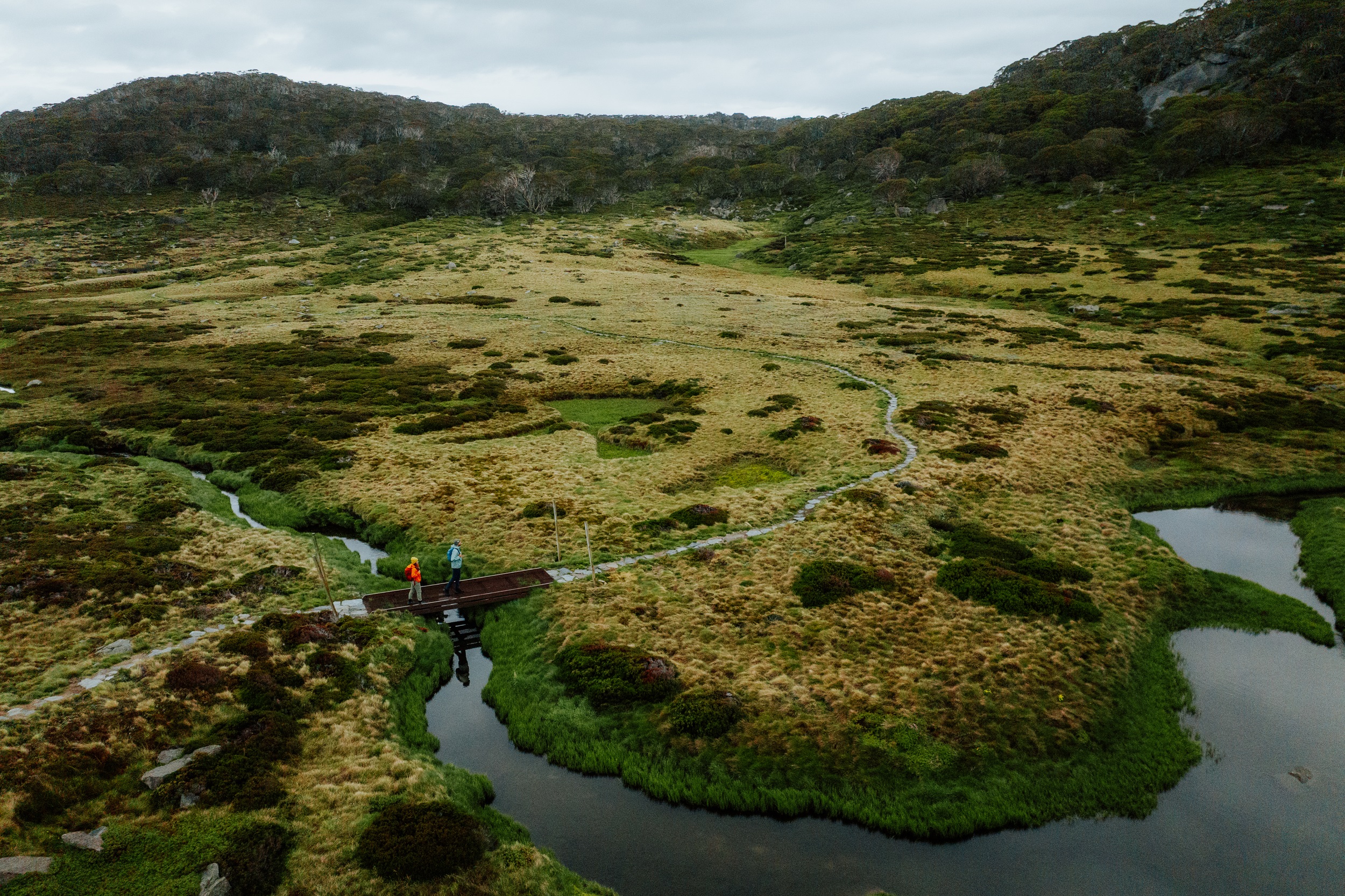 Two people walking on the Charlotte Pass Village to Perisher​ Valley section of the Snowies Alpine Walk. Photo credit: Daniel Parsons/DCCEEW © Studio Bilby