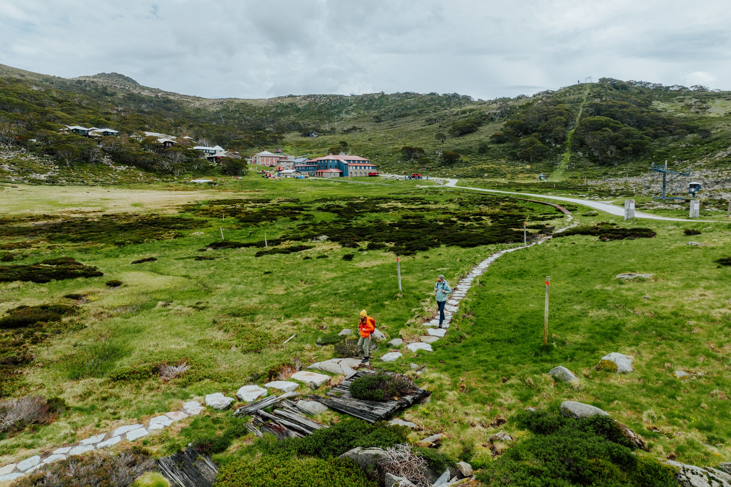 Two people walking on the Charlotte Pass Village to Perisher​ Valley section of the Snowies Alpine Walk. Photo credit: Daniel Parsons/DCCEEW © Studio Bilby