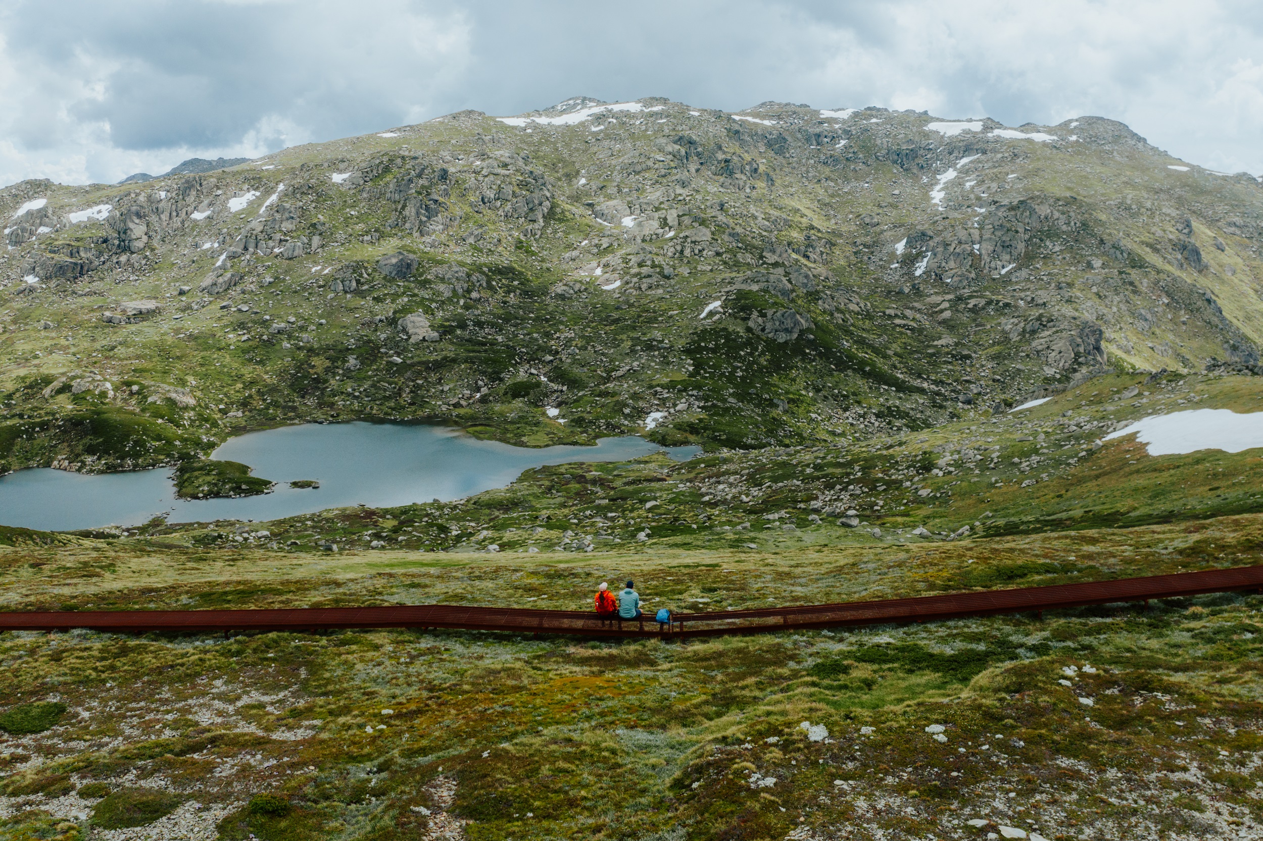 Walkers take in veiws of the mountains on the Main Range section of the Snowies Alpine Walk. Photo credit: Daniel Parsons/DCCEEW © Studio Bilby