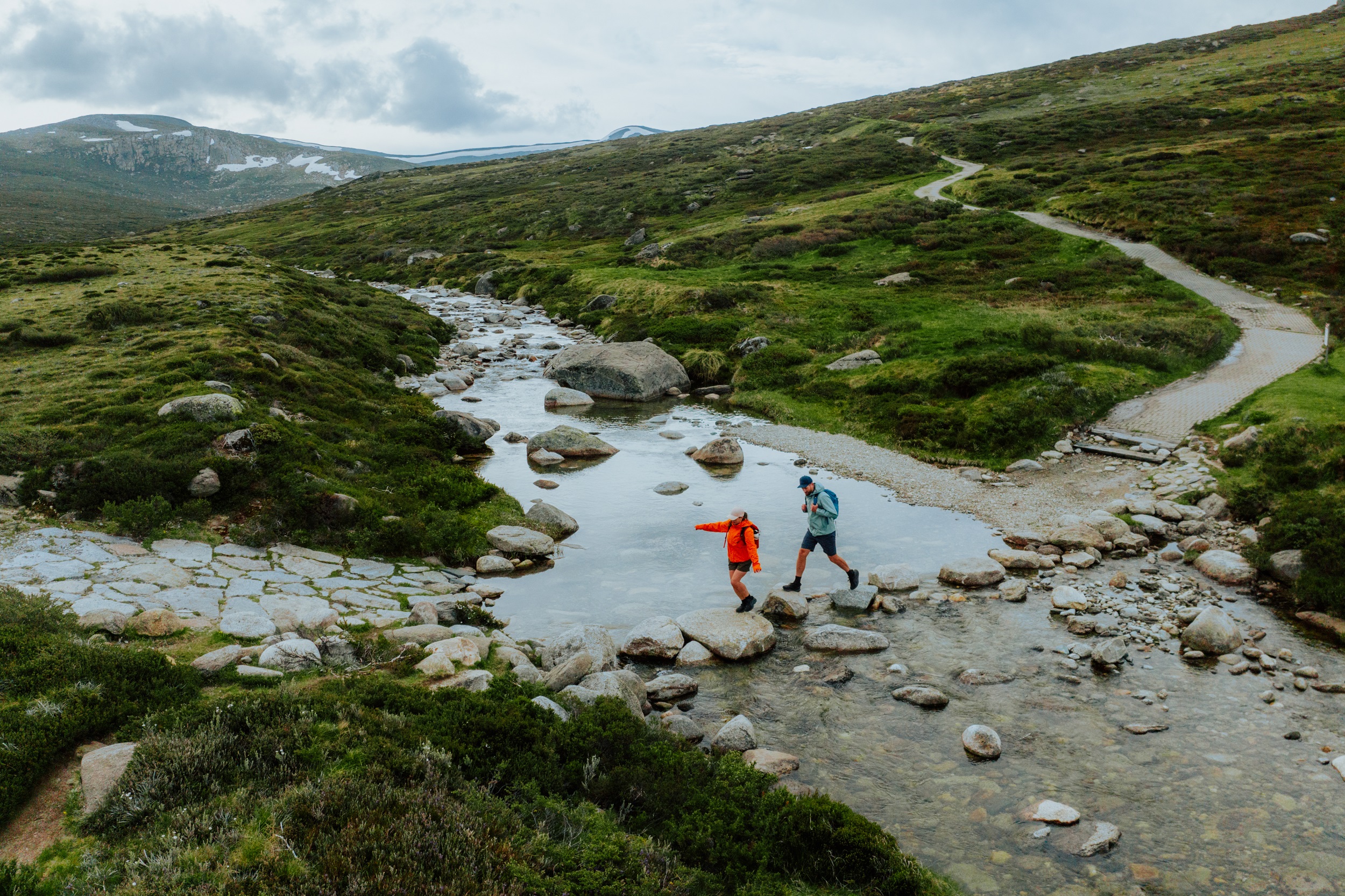 Two walkers on the Main Range walk section of the Snowies Alpine Walk. Photo: Daniel Parsons / DCCEEW © Studio Bilby