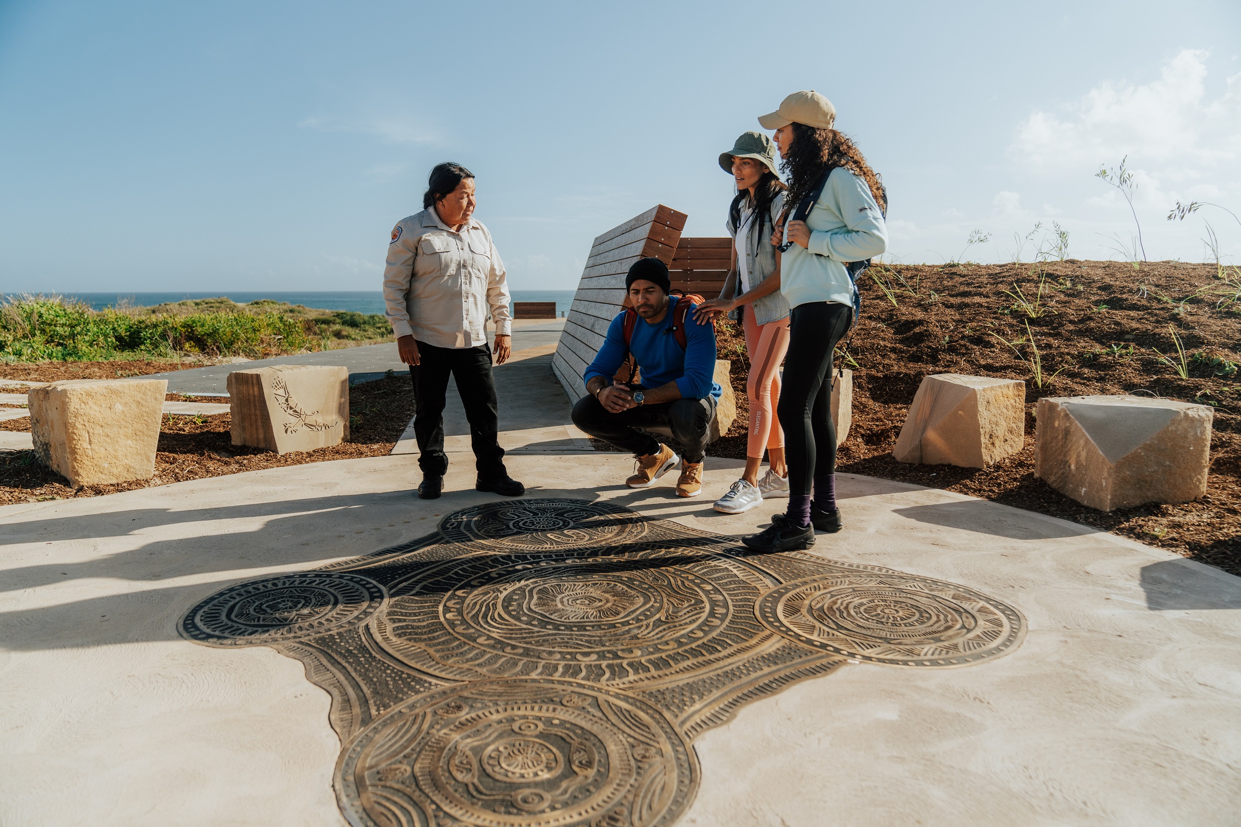 Visitors learn about Aboriginal culture at Birubi Point Aboriginal Place in Tomaree National Park. Photo credit: Remy Brand/DCCEEW © Studio Bilby