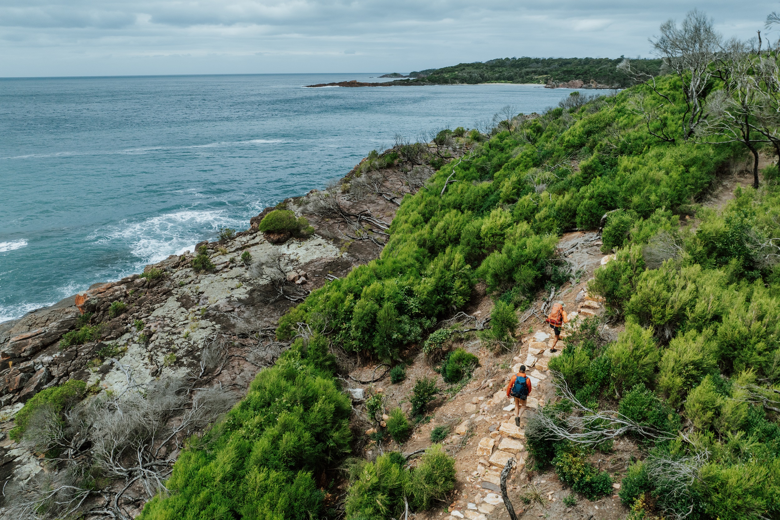 Two walkers at Bobs Rock on the Light to Light Walk. Photo Credit: Daniel Parsons/DCCEEW © Studio Bilby