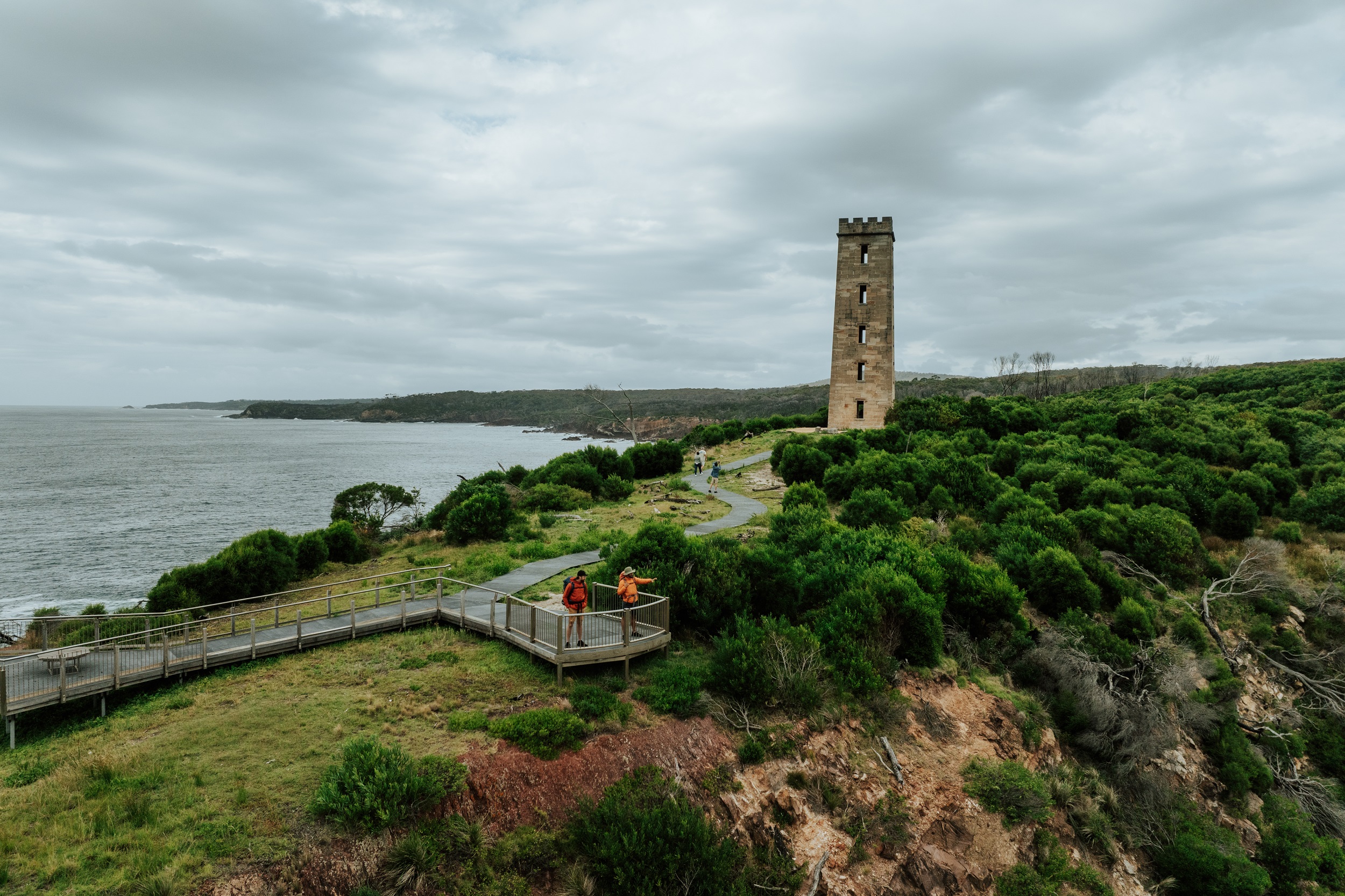 Two walkers check out the view from the lookout at Boyds Tower on the Light to Light Walk. Photo credit: Daniel Parsons/DCCEEW © Studio Bilby