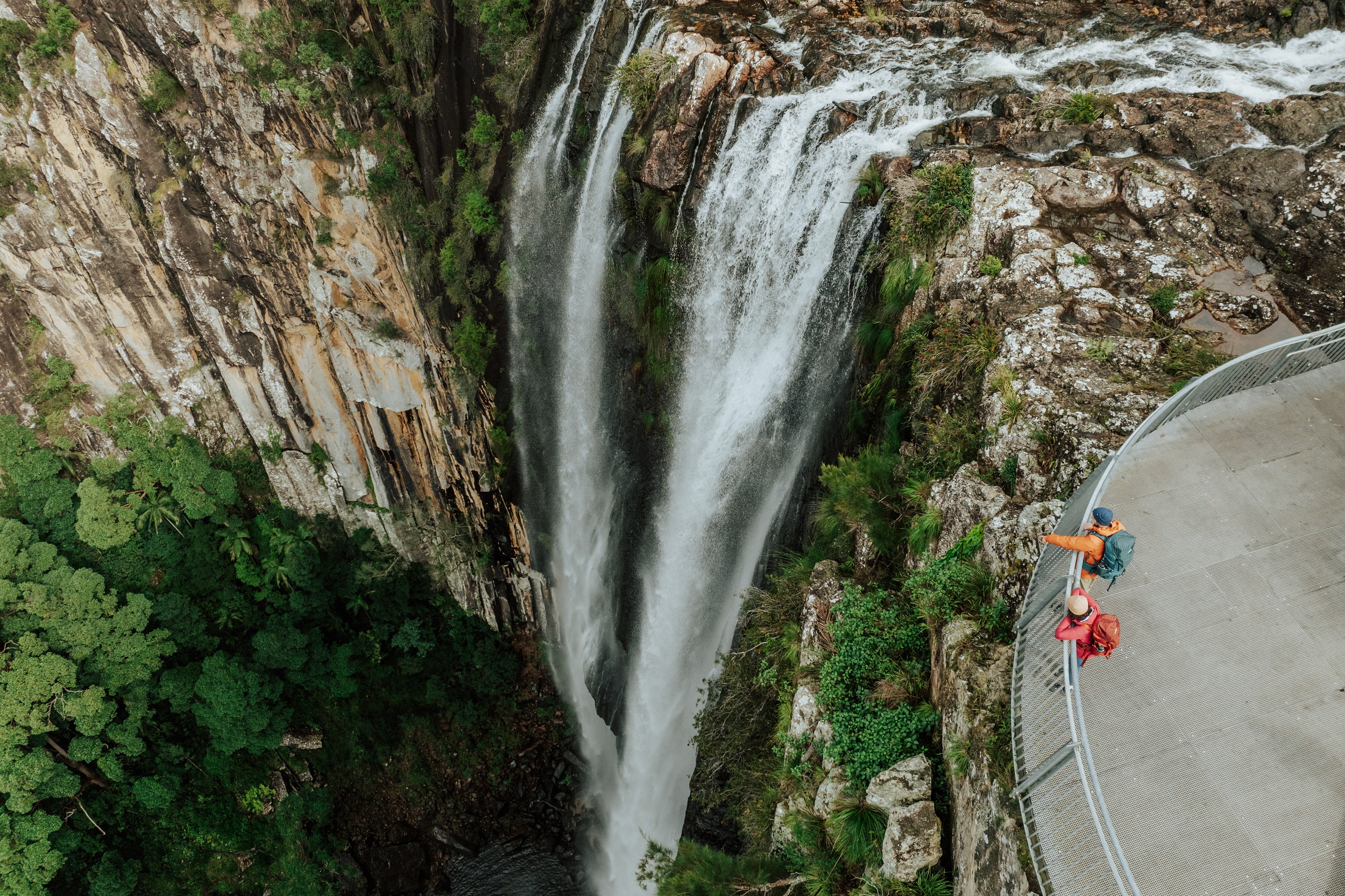 Two hikers check out the epic view from Minyon Falls lookout. Photo: Daniel Parsons/DCCEEW © Studio Bilby