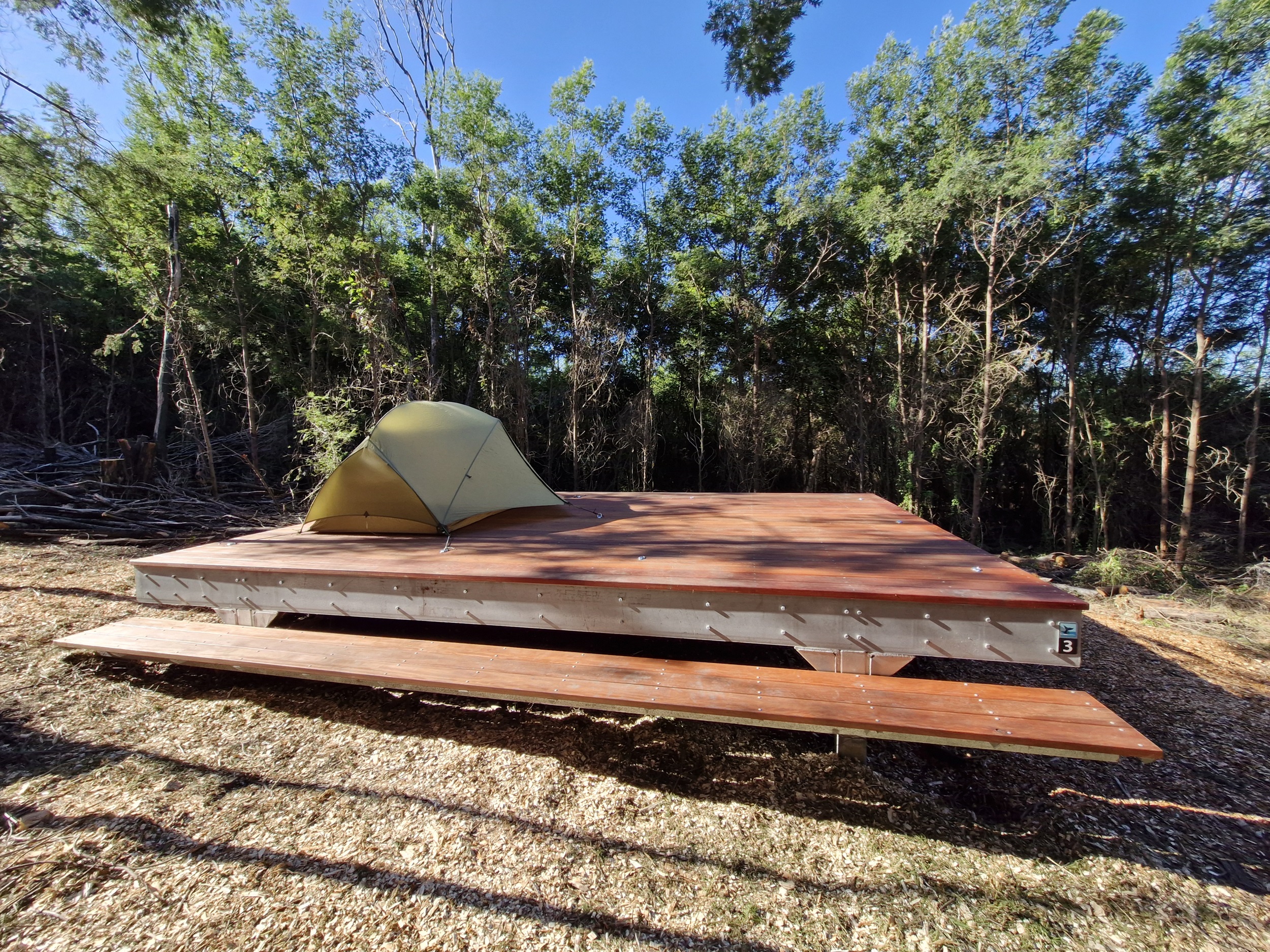 Tent set up on a camping platform at Hegarts campground on the Light to Light Walk. Photo: Sam Doherty/DCCEEW © DCCEEW