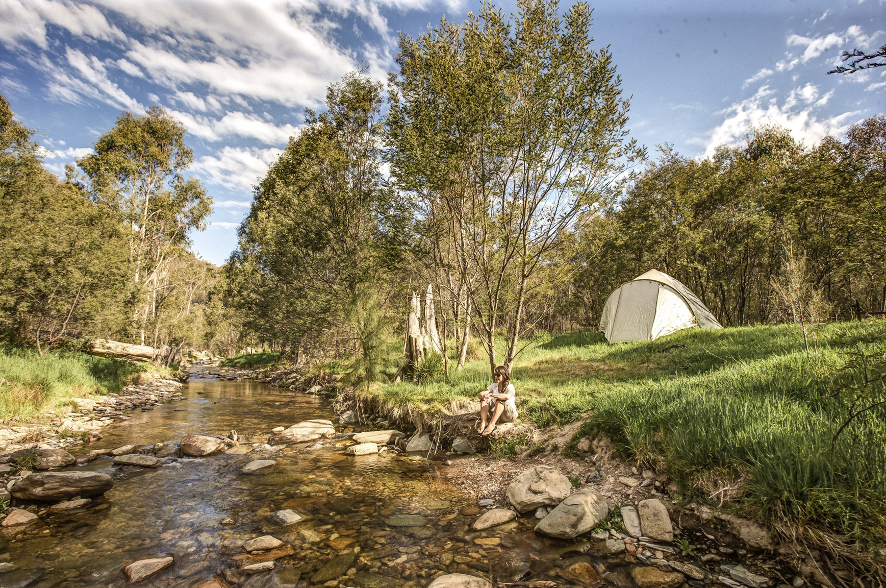 A woman sitting by the river at Flea Creek campground. Photo: Murray Vanderveer/DCCEEW © DCCEEW