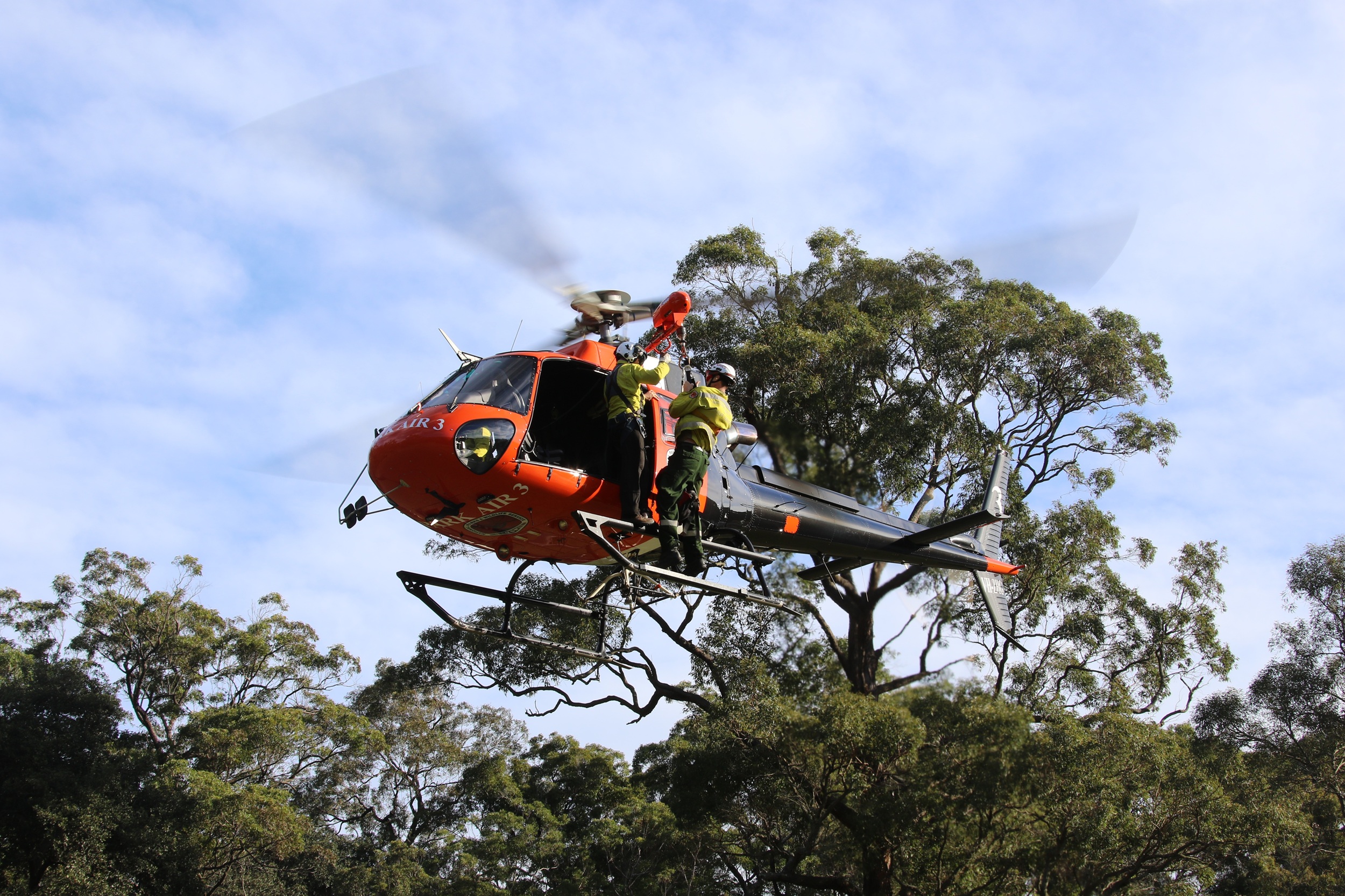 NPWS rangers in a helicopter. Photo: David Croft/DCCEEW © DCCEEW