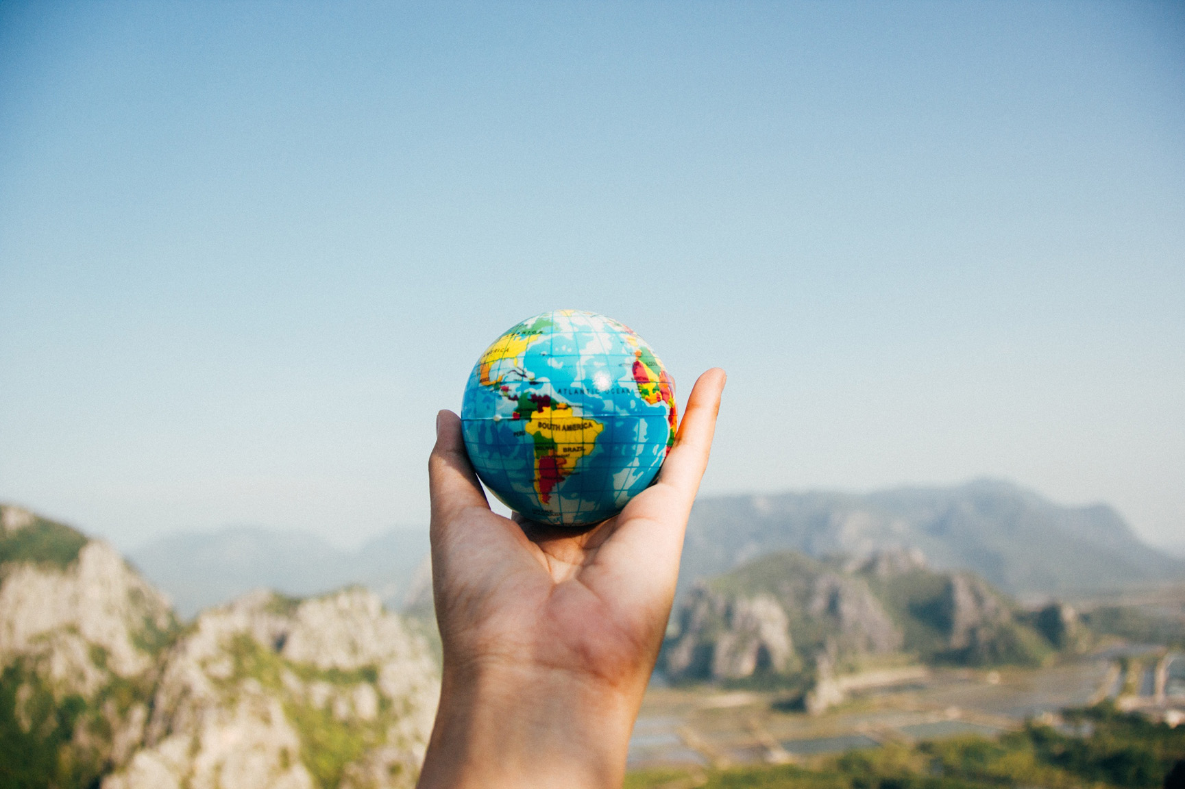 Hand holding a small globe. Photo: Pexels/Porapak Apichodilok © Pexels
