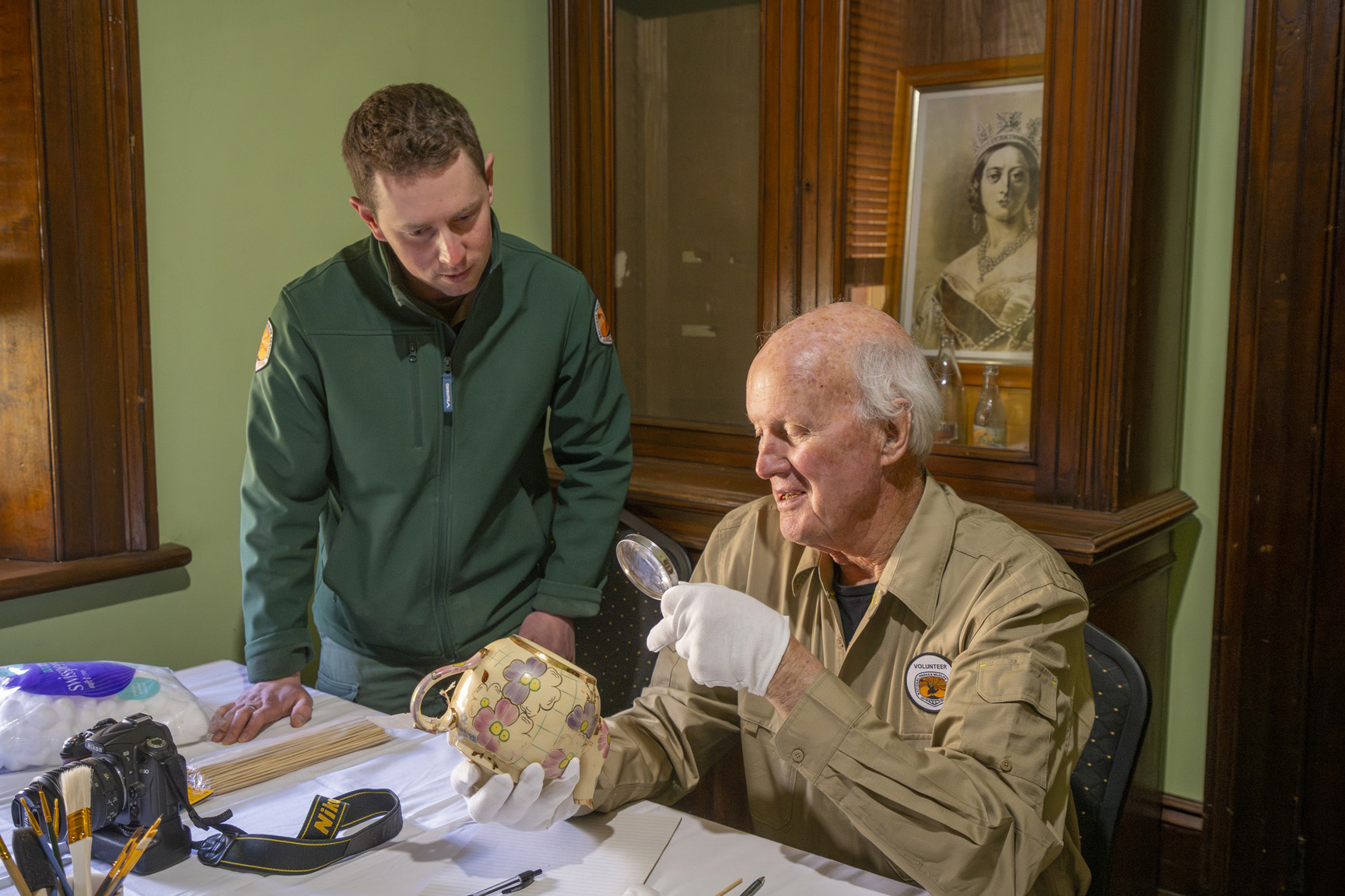 Volunteers inspect historical objects at Hartley Historic Site. Photo: John Spencer/DCCEEW © DCCEEW