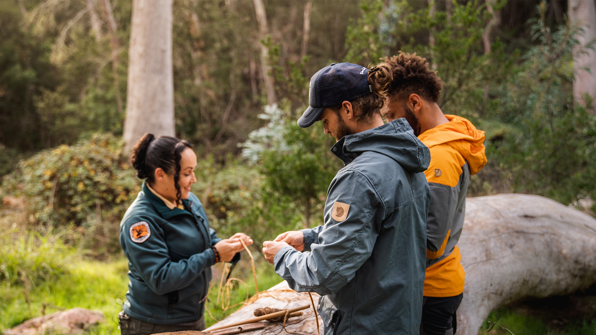 Visitors and NPWS staff taking part in cultural activities in a national park. Photo: Rob Mulally / DCCEEW © DCCEEW 