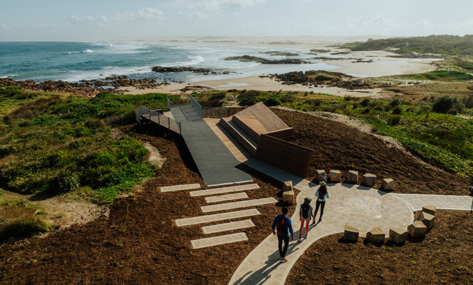 Aerial photo showing people on the boardwalk at Birubi Point Aboriginal Place and the cultural artwork by Worimi man, Gerard Black. Credit: Daniel Parsons &copy; Daniel Parsons