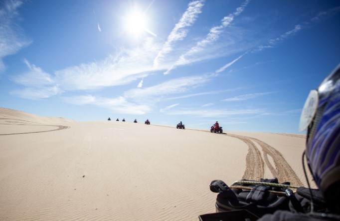Quad bikers riding on Worimi sand dunes. Photo: Sand Dune Adventures &copy; Sand Dune Adventures