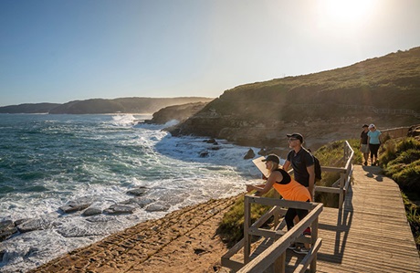 Two people on Bouddi Coastal Walk on a viewing platform for whale watching. Credit: John Spencer &copy; DCCEEW