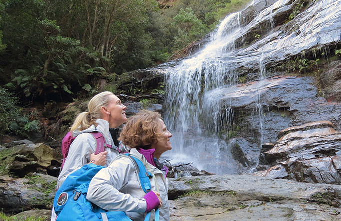Two women viewing a waterfall on a luxury Blue Mountains trekking trip with GirlsTrek. Photo: Helen Lucas &copy; GirlsTrek
