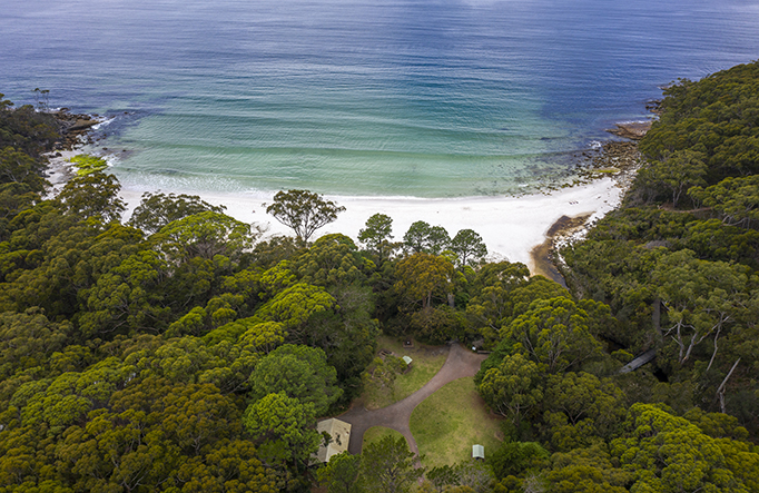 An aerial shot of Greenfield Beach and lawn in Murramarang National Park. Photo: John Spencer &copy; DPIE