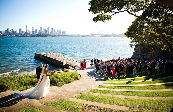 A couple walking down the path towards the water at Bradleys Head Amphitheatre in Sydney Harbour National Park. Photo: &copy; McKay Photography