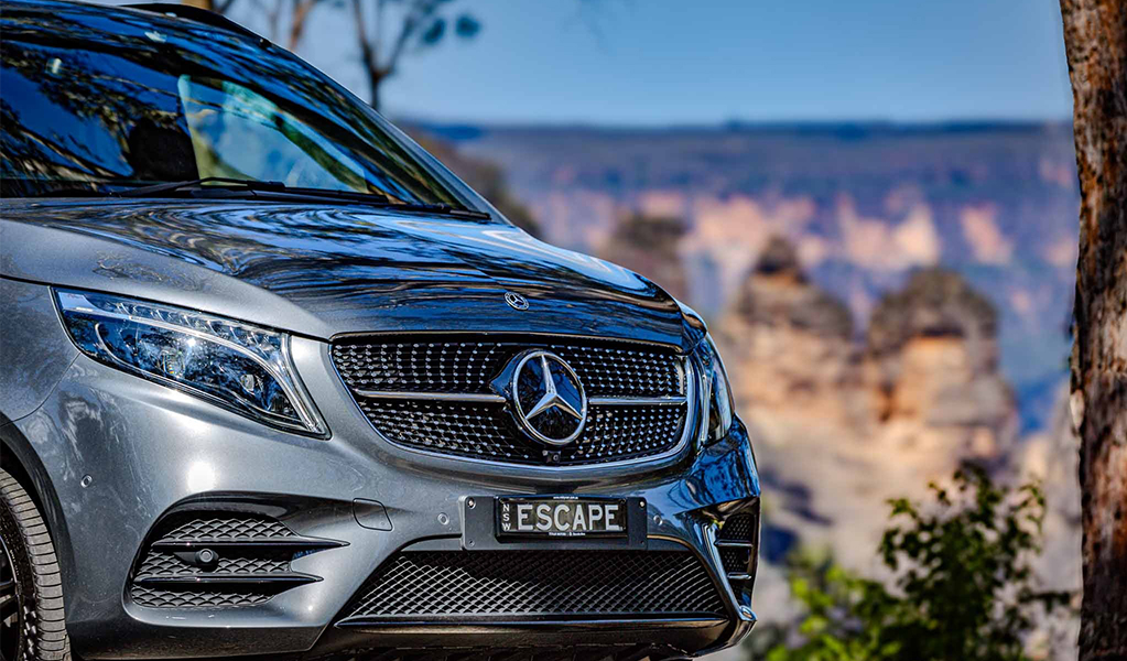 A Mercedes car driving in Blue Mountains National Park past the Three Sisters. Credit &copy; David Edwards