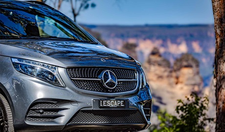 A Mercedes car driving in Blue Mountains National Park past the Three Sisters. Credit &copy; David Edwards