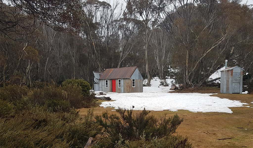 Horse Camp Hut surrounded by bush and snow in Kosciuszko National Park. Credit: Irini Malliaros &copy; Heritage Hikes Australia