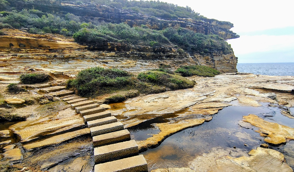 Steps over rock pools on a cliff edge in the Royal National Park along the Coast Track. Credit &copy; Jamie Lowe