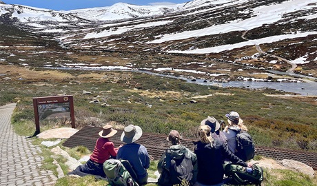 A tour group with She Wanders Escapes looking at snow-capped mountains in Kosciuszko National Park. Credit: Camilla Skye &copy; She Wanders Escapes