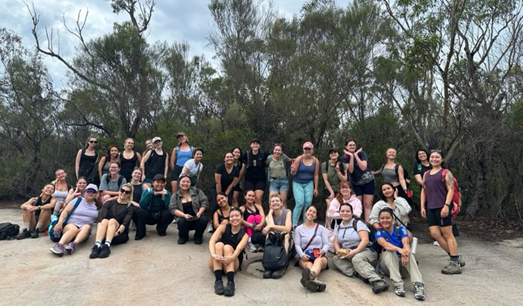 A group of women sitting in the bush on a guided tour with TrailBabes Sydney. Credit: Tessa &copy; TrailBabes Sydney