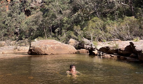 Woman swimming in Glenbrook Gorge in Blue Mountains National Park after bushwalking with Wonders of Nature Eco Tours. Credit: Hannah Bowman &copy; Wonders of Nature Eco Tours