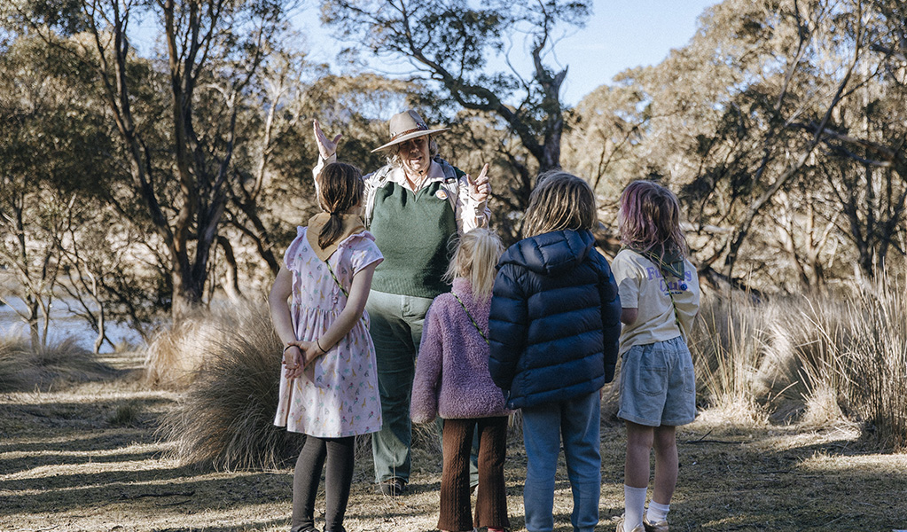 A Discovery ranger showing kids through the bush on a guided tour. Credit: Breanna A Photography &copy; DCCEEW