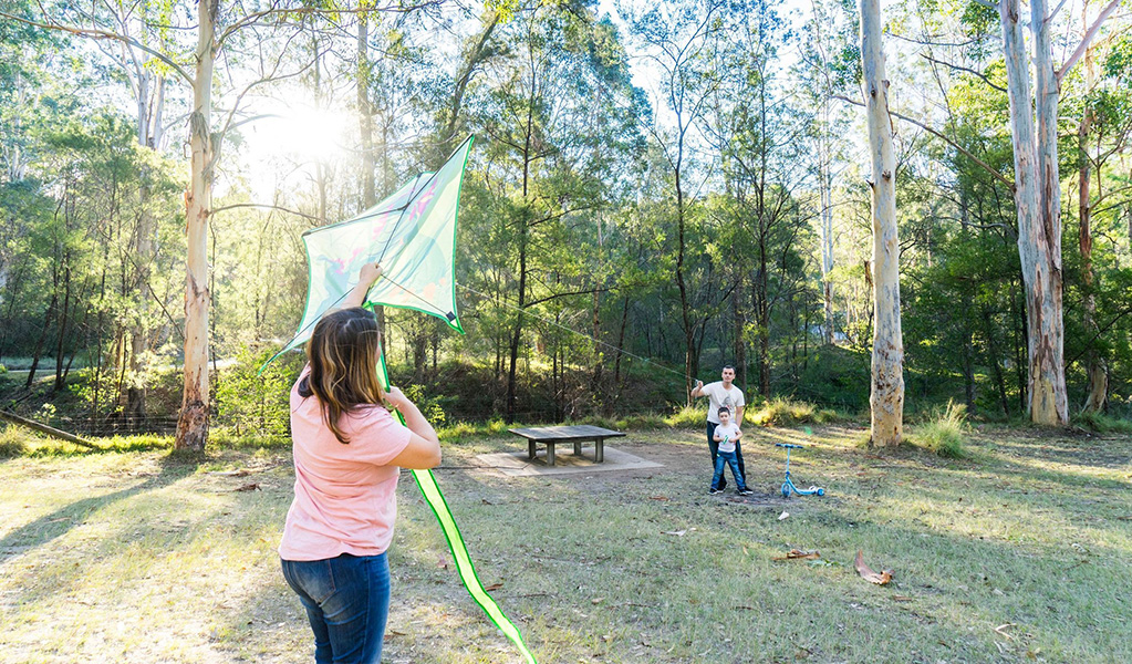 Family flying a kite at Depot Beach campground. Credit: Simone Cottrell &copy; DPE
