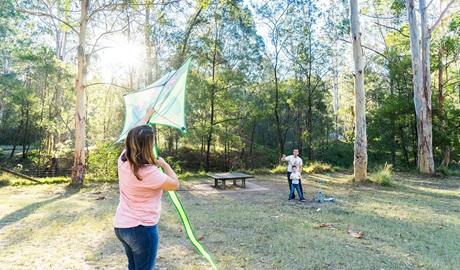 Family flying a kite at Depot Beach campground. Credit: Simone Cottrell &copy; DPE