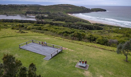 Aerial view of people looking out over Killalea beach from the headland platform in Killalea Regional Park. Credit: John Spencer &copy; DCCEEW