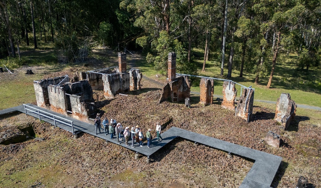 Tour group walking along a raised platform at Innes Ruins Historic Site. Credit: John Spencer &copy; DCCEEW