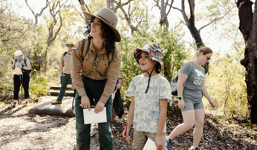 A Discovery guide showing kids around the bushland near Pretty Beach in Murramarang National Park. Credit &copy; Zain Kruyer/DCCEEW