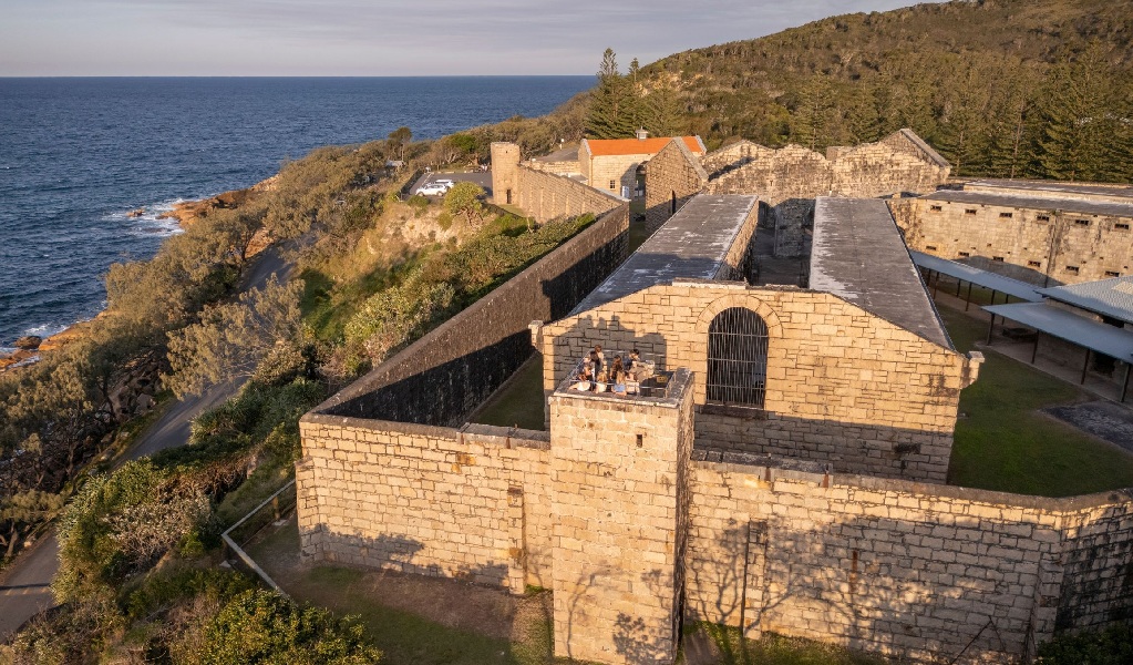 An aerial view of Trial Bay Goal in Arakoon National Park with a group standing in the watchtower on a guided tour. Credit: John Spencer &copy; DCCEEW