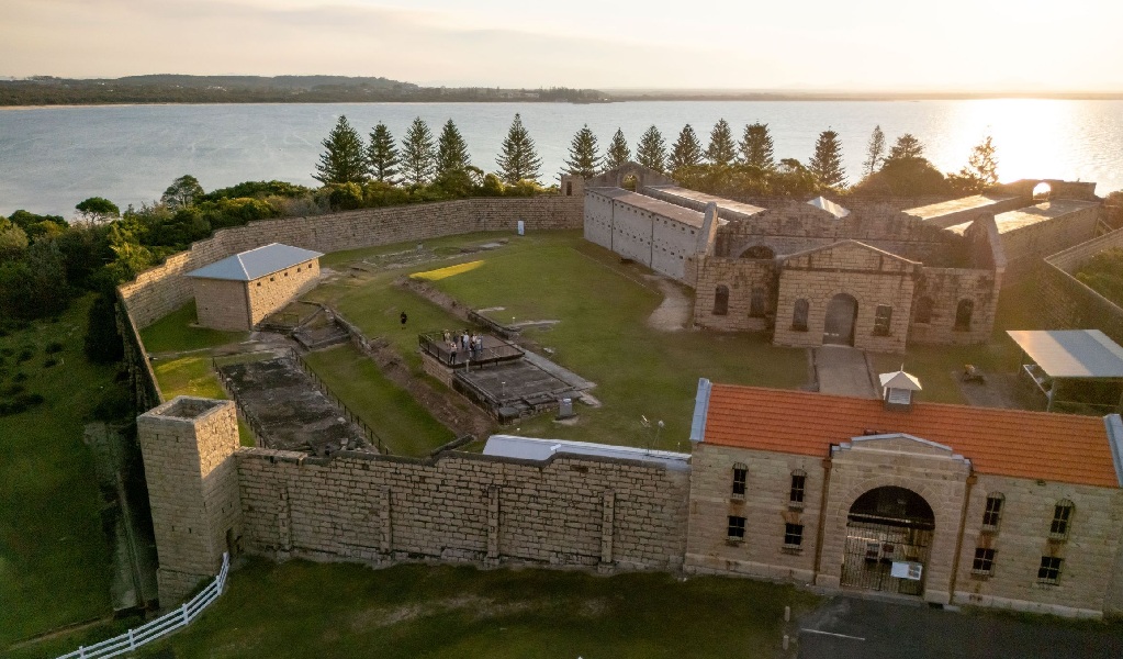 An aerial view of the entrance gates of Trial Bay Gaol in Arakoon National Park at sunset. Credit: John Spencer &copy; DCCEEW