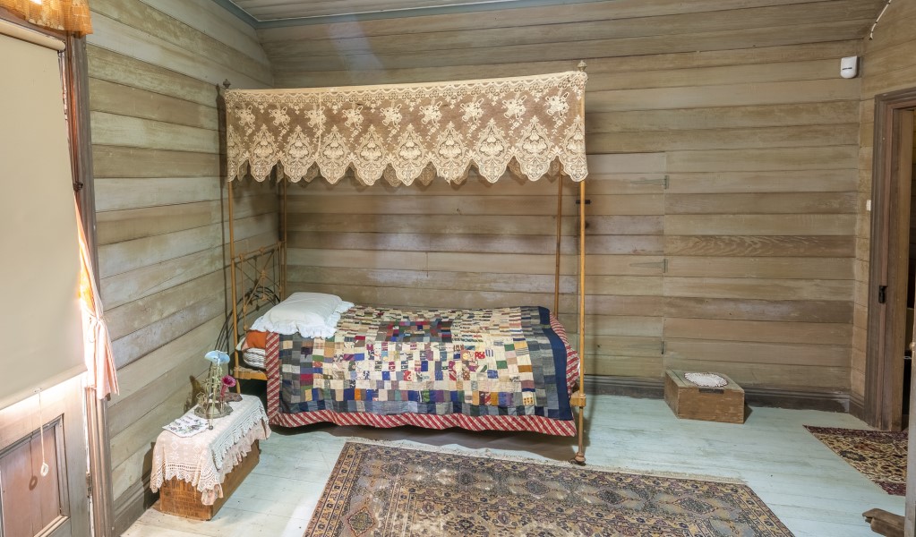 A bed with canopy in one of the bedrooms at Craigmoor House, Hill End Historic Site. Photo: John Spencer &copy; DPE