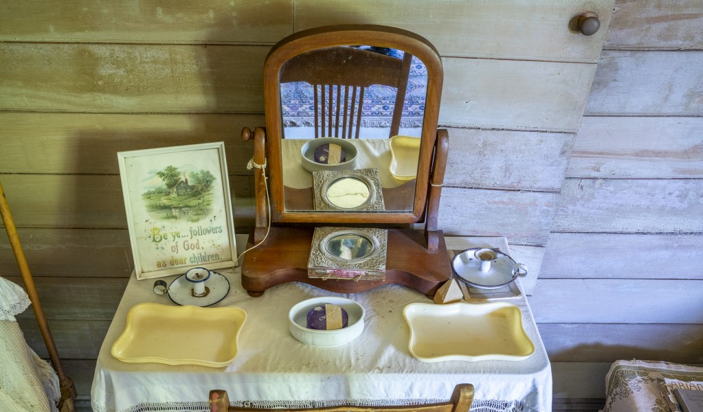 A night table next to the beds in the room with the Juliet balcony at Craigmoor House, Hill End Historic Site. Photo: John Spencer &copy; DPE