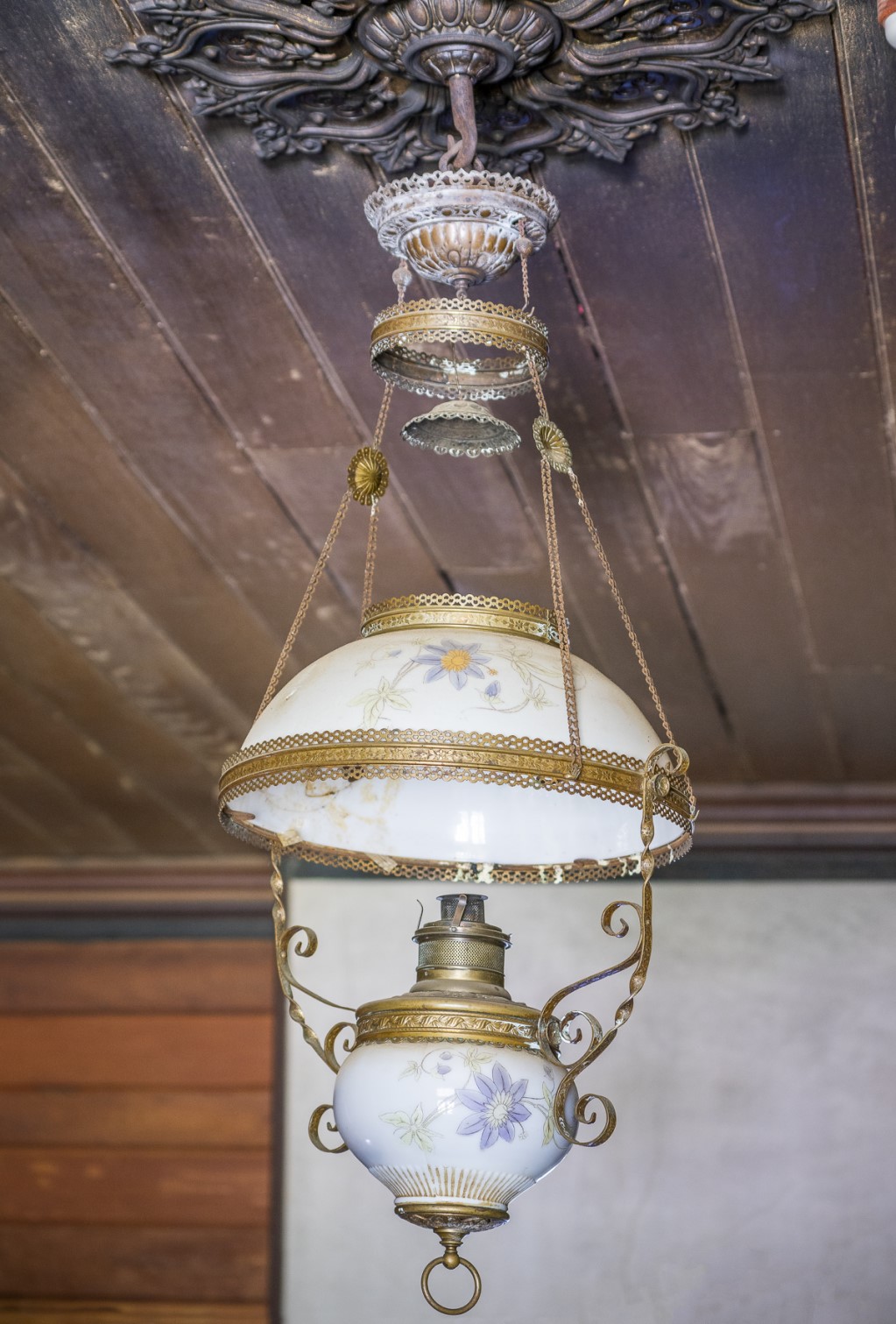 A kerosene light and blackened ceiling in the dining room at Craigmoor House. Photo: John Spencer &copy; DPE