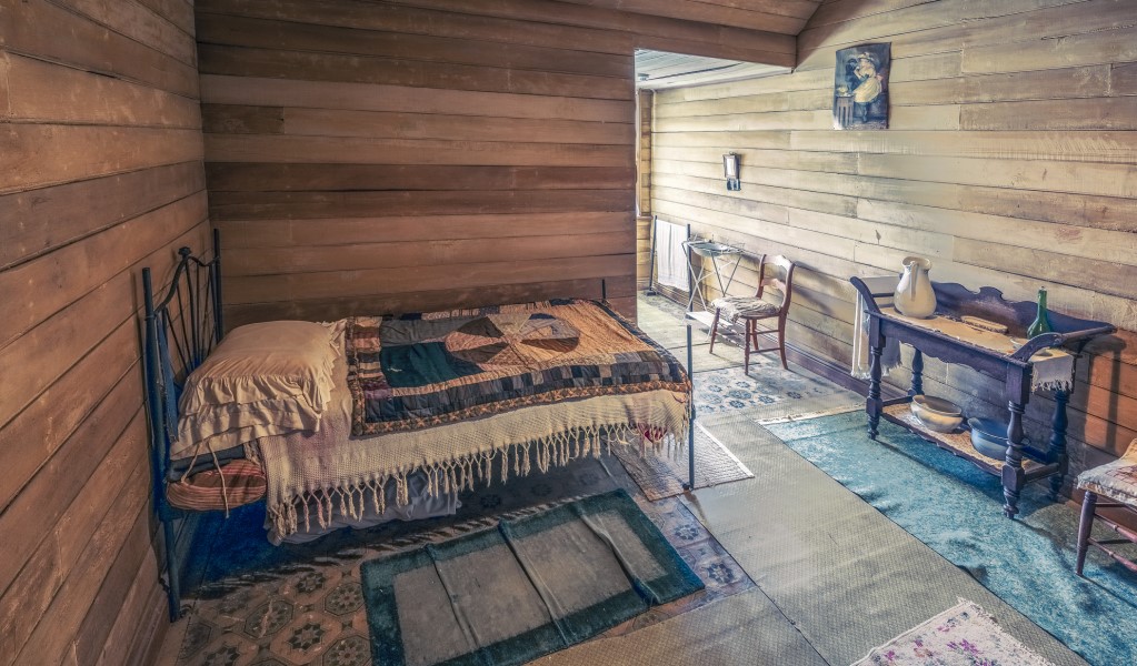 A bed in one of the upstairs bedrooms at Craigmoor House, Hill End Historic Site. Photo: John Spencer &copy; DPE