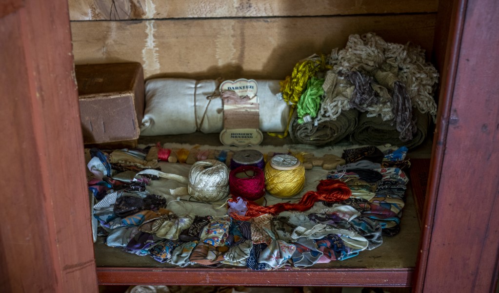A shelf full of sewing materials in the cupboard upstairs at Craigmoor House. Photo: John Spencer &copy; DPE