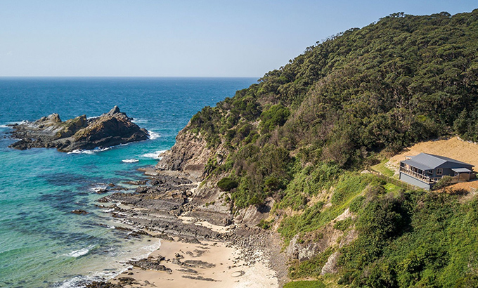 Aerial view of Davies Cottage, set on a hill above Boat Beach and Sugarloaf Bay in Myall Lakes National Park. Photo: John Spencer © DPIE