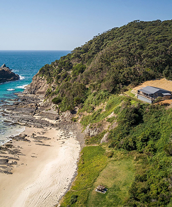Aerial view of Davies Cottage, set on a hill above Boat Beach and Sugarloaf Bay in Myall Lakes National Park. Photo: John Spencer © DPIE