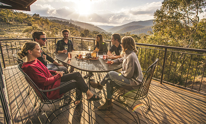 Group of friends on the balcony of Creel Lodge at sunset. Photo: Boen Ferguson/OEH