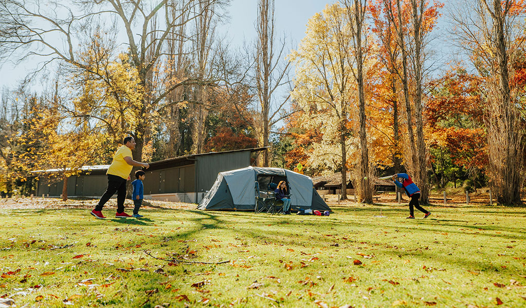 A family at Wombeyan Caves campground in autumn. Credit: Remy Brand/DCCEEW &copy; Remy Brand