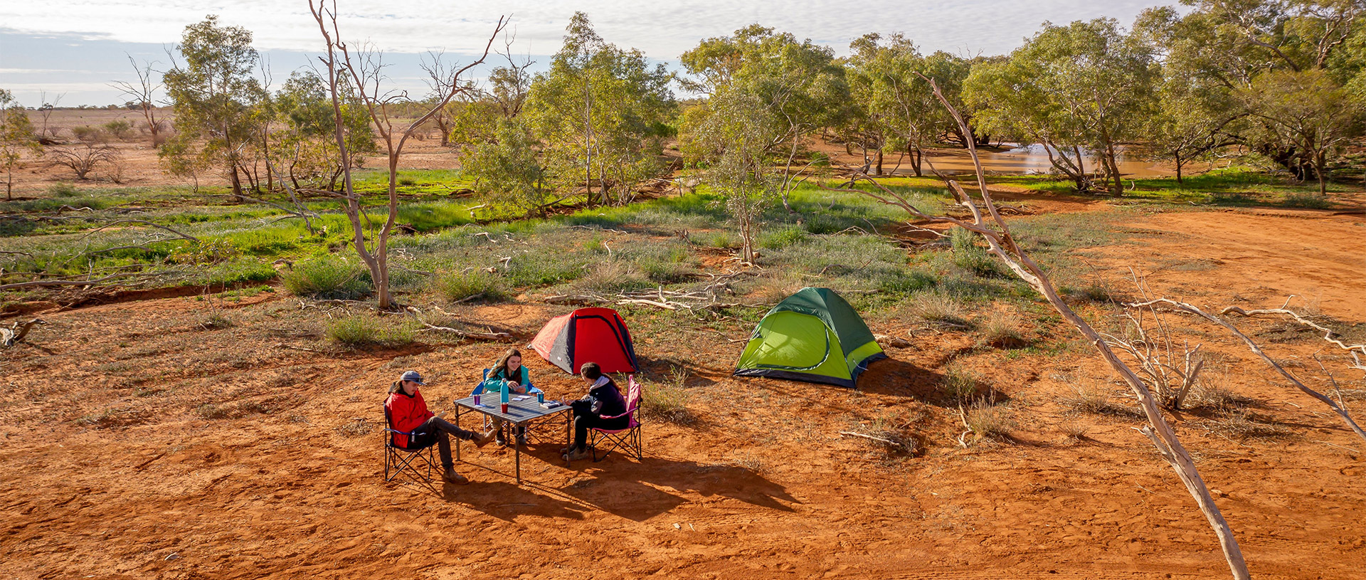 A group of friends camping at Mount Wood campground in Sturt National Park. Credit: John Spencer &copy; DCCEEW