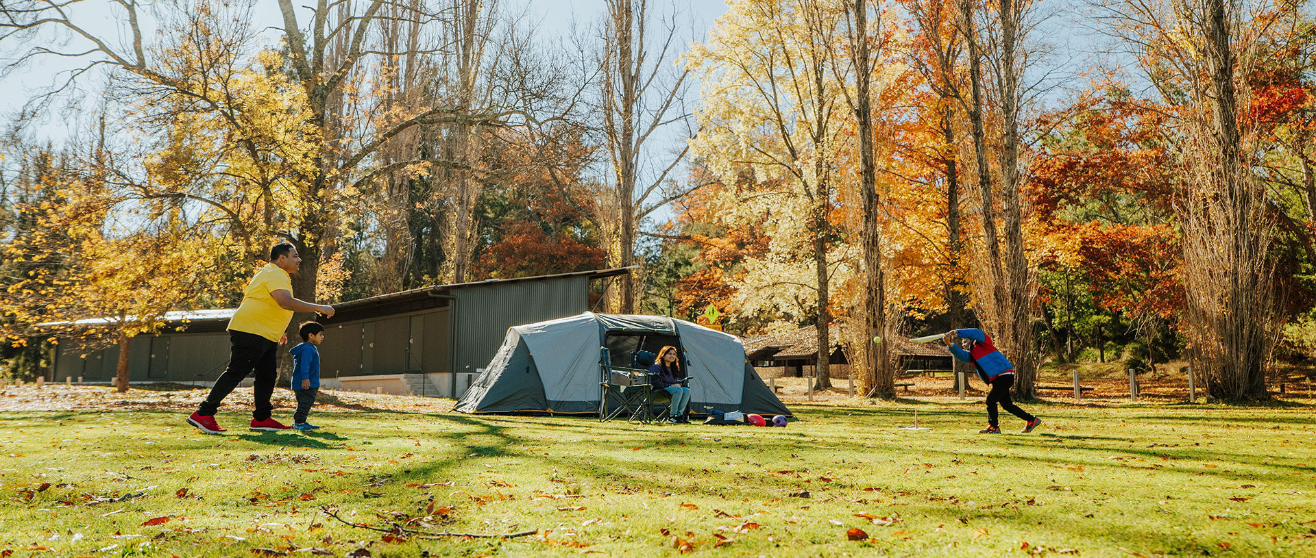 A family at Wombeyan Caves campground in autumn. Credit: Remy Brand/DCCEEW &copy; Remy Brand