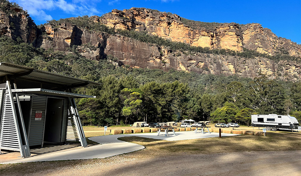 A concrete footpath leading to the accessible toilet at Cooroongooba campground. Credit: DCCEEW