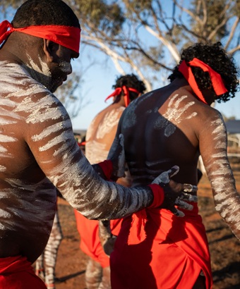 Frederick Henry and the Kulgoodah Dancers in cultural dress getting ready for a performance at Mutawintji Cultural Festival. Credit: Otis Filley &copy; DCCEEW